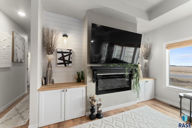 living area featuring visible vents and light wood-style flooring