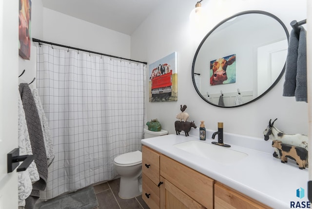 bathroom with tile patterned flooring, toilet, vanity, and a shower with curtain