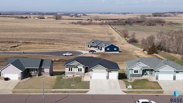 birds eye view of property with a rural view