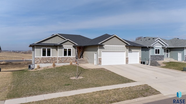 craftsman inspired home with driveway, stone siding, board and batten siding, an attached garage, and a front yard