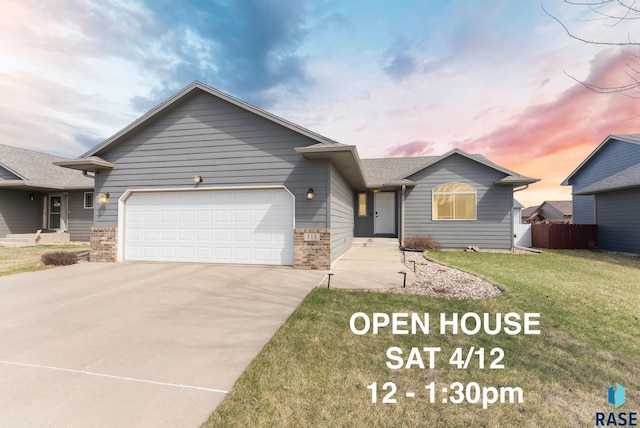 single story home featuring a garage, fence, concrete driveway, brick siding, and a front lawn