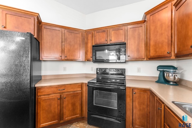 kitchen featuring brown cabinets, light countertops, and black appliances