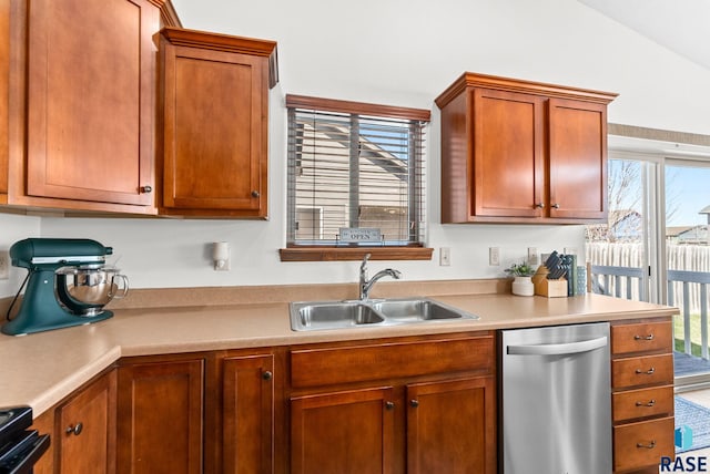 kitchen with electric range oven, dishwasher, a sink, light countertops, and lofted ceiling