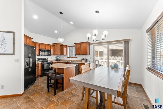 kitchen featuring a sink, light countertops, black appliances, and a wealth of natural light