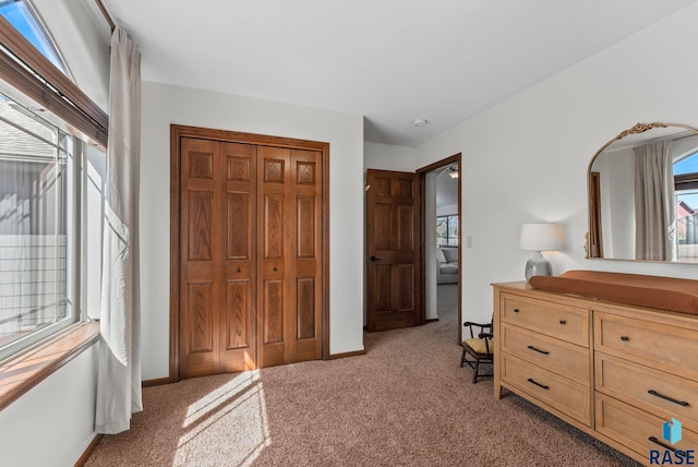 bedroom featuring a closet, baseboards, and carpet floors