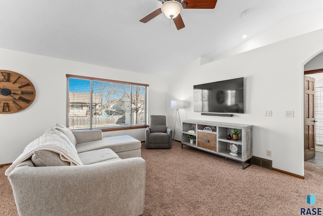 living room featuring baseboards, arched walkways, ceiling fan, carpet floors, and lofted ceiling