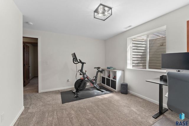 workout area featuring carpet, visible vents, and baseboards