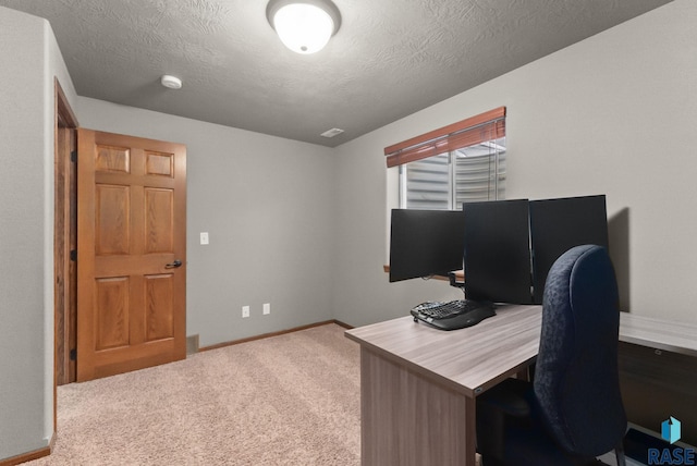 office with a textured ceiling, baseboards, and carpet floors