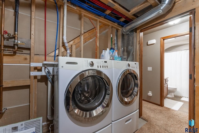 laundry room with carpet floors and washing machine and dryer