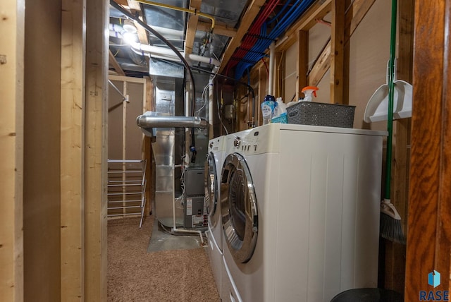 washroom with independent washer and dryer, laundry area, and heating unit