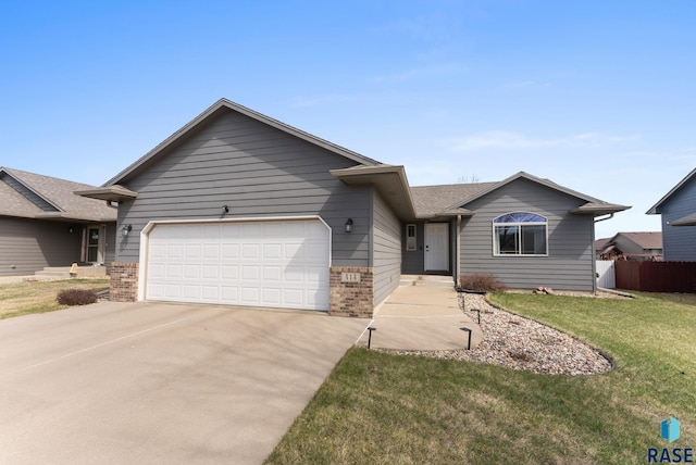 ranch-style home featuring a garage, brick siding, a front lawn, and concrete driveway