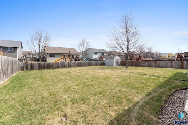 view of yard with an outdoor structure, a residential view, a shed, and a playground