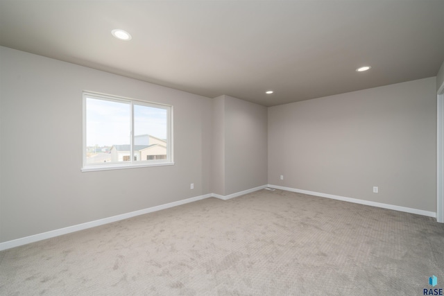 empty room featuring recessed lighting, carpet, and baseboards