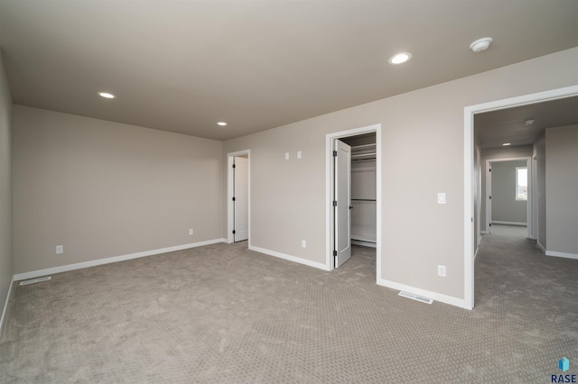 unfurnished bedroom with visible vents, baseboards, recessed lighting, and carpet flooring