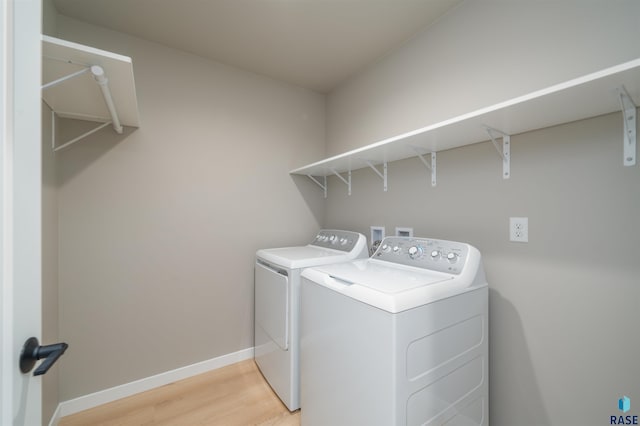 washroom with washer and clothes dryer, light wood finished floors, laundry area, and baseboards