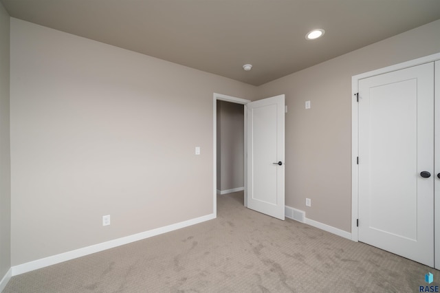 unfurnished bedroom featuring recessed lighting, carpet, visible vents, and baseboards
