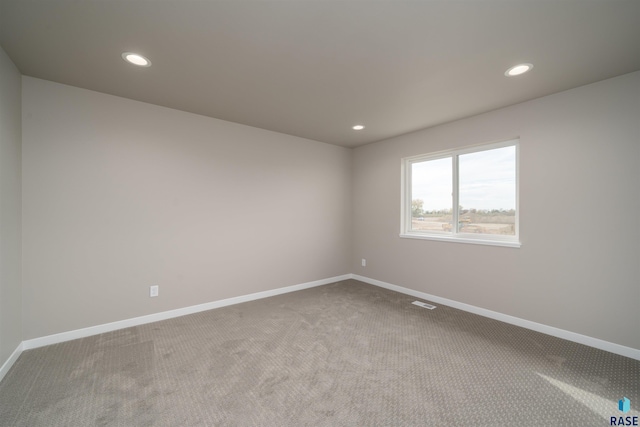 unfurnished room with recessed lighting, carpet, and baseboards