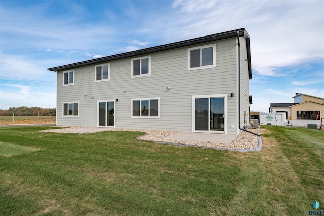 back of house featuring a patio, a lawn, and central air condition unit