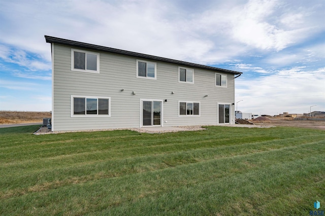 back of house with a yard, a patio, and central air condition unit