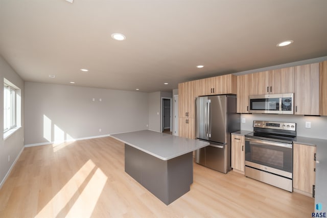 kitchen featuring recessed lighting, light wood-type flooring, light brown cabinets, and stainless steel appliances