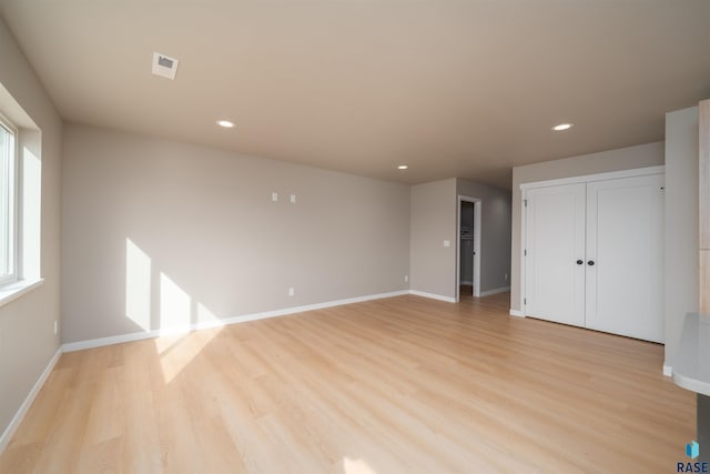 unfurnished room with visible vents, baseboards, light wood finished floors, and recessed lighting