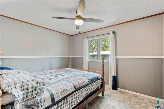 1200 Crestview Dr, Vermillion, SD 57069 - carpeted bedroom with a decorative wall, a textured ceiling, crown molding, and a ceiling fan