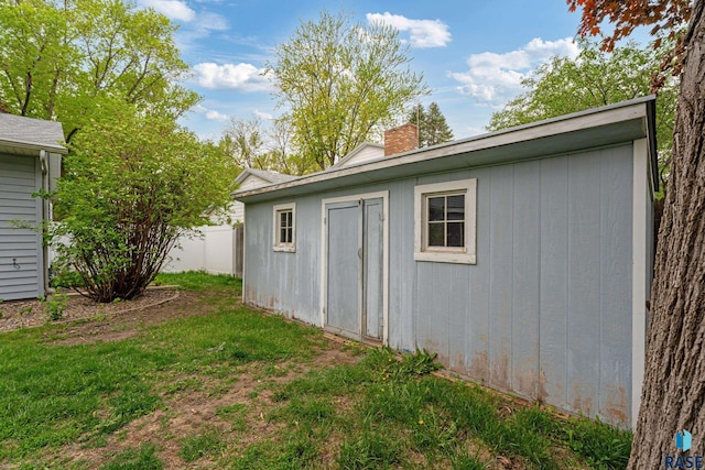 1200 Crestview Dr, Vermillion, SD 57069 - view of home's exterior with a chimney and an outdoor structure
