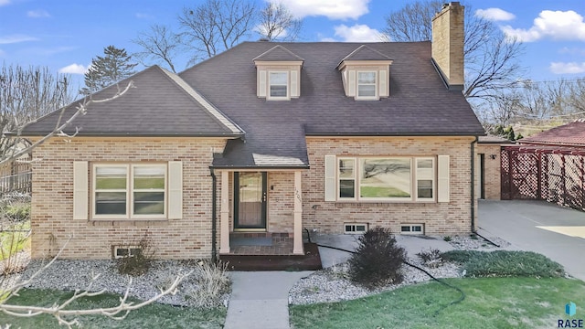 1205 Douglas Ave, Yankton, SD 57078 - view of front of house with brick siding, roof with shingles, and a chimney