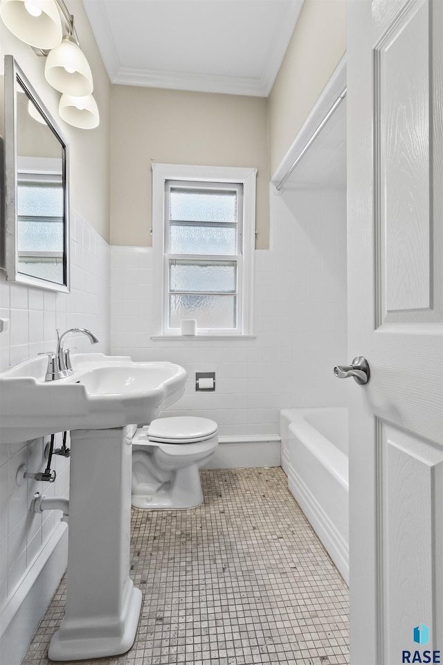 1205 Douglas Ave, Yankton, SD 57078 - bathroom with toilet, ornamental molding, a wealth of natural light, and tile walls