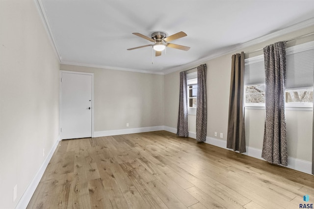 1205 Douglas Ave, Yankton, SD 57078 - spare room featuring crown molding, wood finished floors, ceiling fan, and baseboards