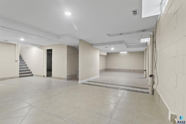 1205 Douglas Ave, Yankton, SD 57078 - finished below grade area with recessed lighting, stairway, visible vents, and tile patterned flooring