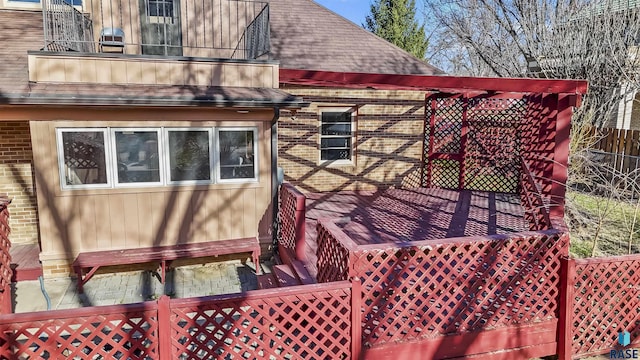 1205 Douglas Ave, Yankton, SD 57078 - view of property exterior featuring roof with shingles, brick siding, and a balcony