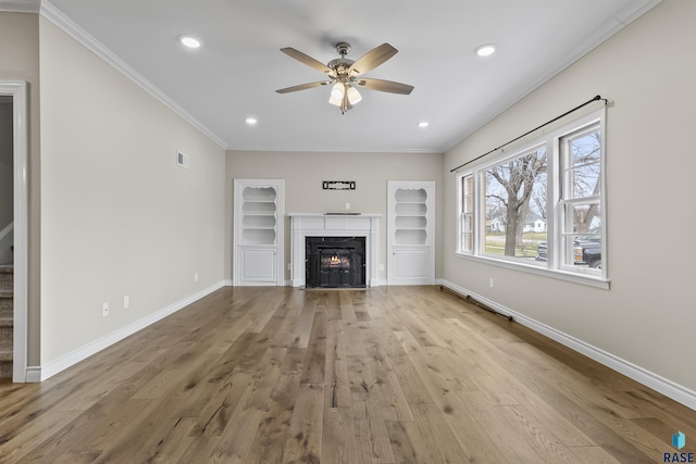 1205 Douglas Ave, Yankton, SD 57078 - unfurnished living room featuring crown molding, wood finished floors, ceiling fan, and baseboards
