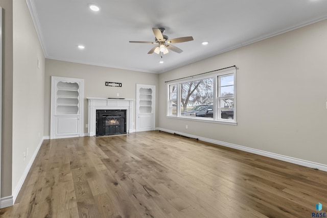 1205 Douglas Ave, Yankton, SD 57078 - unfurnished living room featuring crown molding, wood finished floors, ceiling fan, and baseboards
