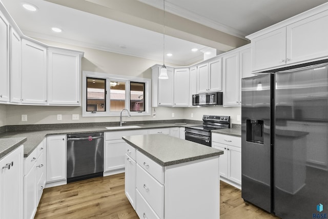 1205 Douglas Ave, Yankton, SD 57078 - kitchen featuring appliances with stainless steel finishes, light wood finished floors, a sink, and white cabinets