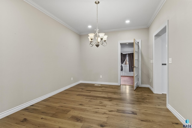 1205 Douglas Ave, Yankton, SD 57078 - unfurnished dining area with crown molding, an inviting chandelier, and wood finished floors