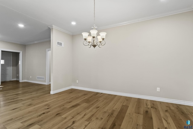 1205 Douglas Ave, Yankton, SD 57078 - unfurnished dining area featuring crown molding, visible vents, a chandelier, wood finished floors, and baseboards