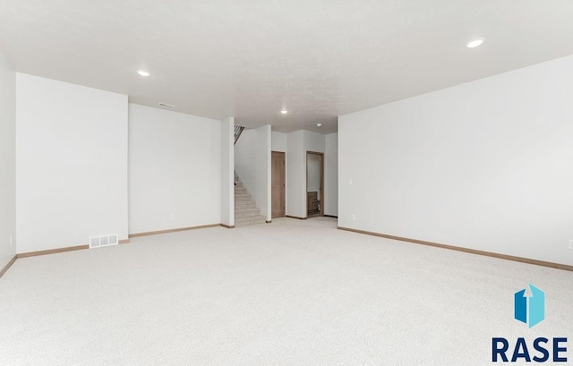 5709 S Spirea Ave, Sioux Falls, SD 57106 - carpeted spare room featuring visible vents, baseboards, recessed lighting, and stairs