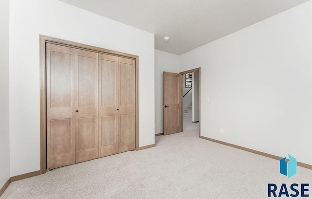 5709 S Spirea Ave, Sioux Falls, SD 57106 - bedroom with a closet, baseboards, and light colored carpet