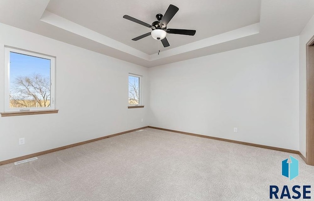 5709 S Spirea Ave, Sioux Falls, SD 57106 - carpeted empty room with a tray ceiling, baseboards, and visible vents
