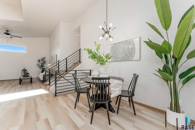 5709 S Spirea Ave, Sioux Falls, SD 57106 - dining space featuring stairway, ceiling fan with notable chandelier, baseboards, and wood finished floors