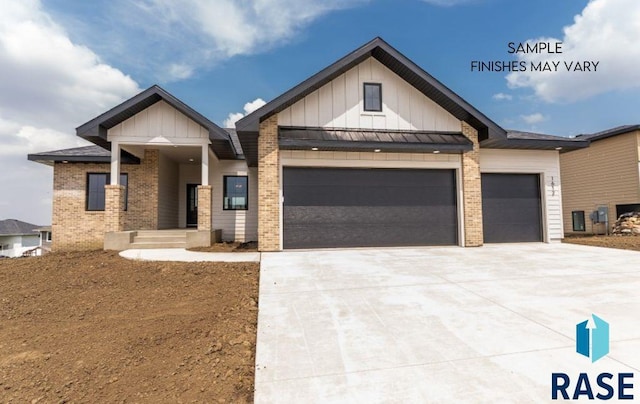 8312 E Wicker Ct, Sioux Falls, SD 57110 - view of front of house with concrete driveway, brick siding, board and batten siding, and an attached garage