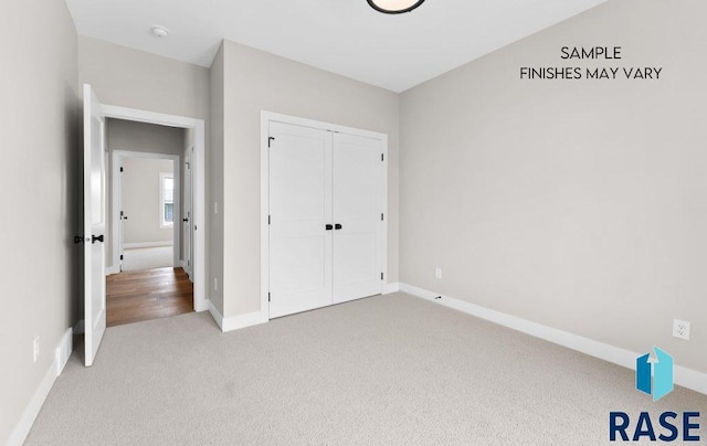 8312 E Wicker Ct, Sioux Falls, SD 57110 - unfurnished bedroom featuring a closet, baseboards, and carpet floors