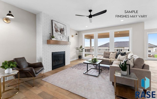 8312 E Wicker Ct, Sioux Falls, SD 57110 - living area with wood finished floors, ceiling fan, a brick fireplace, and recessed lighting