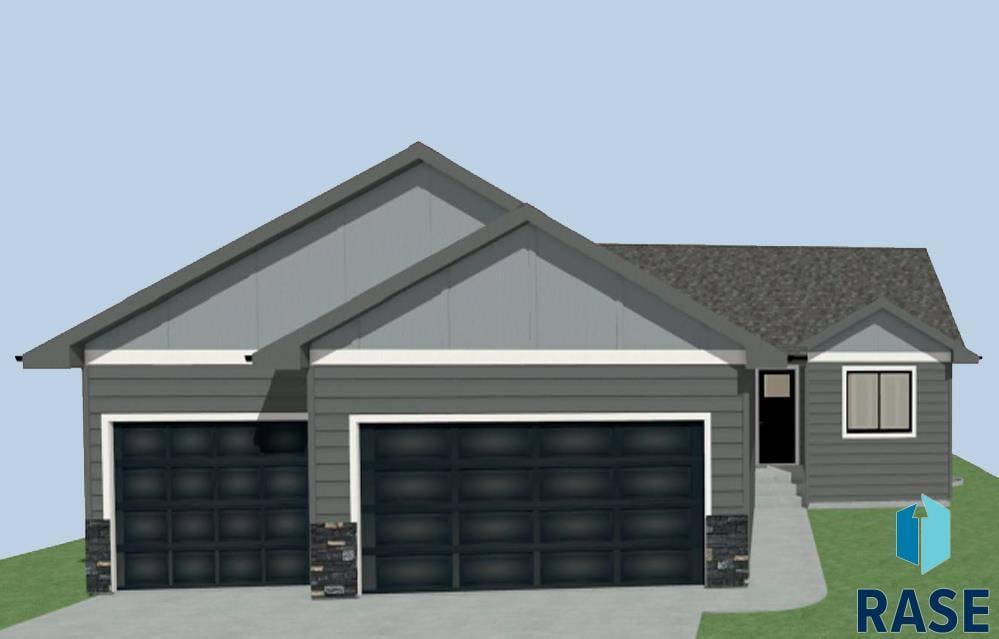 6900 W 5th St, Sioux Falls, SD 57107 - view of front of home with an attached garage, stone siding, and driveway
