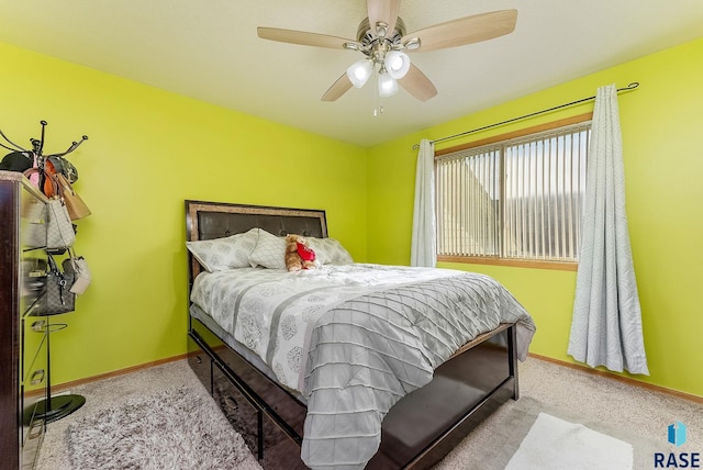 carpeted bedroom featuring ceiling fan and baseboards
