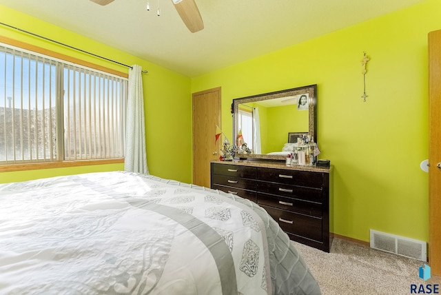 bedroom featuring carpet flooring, visible vents, baseboards, and ceiling fan