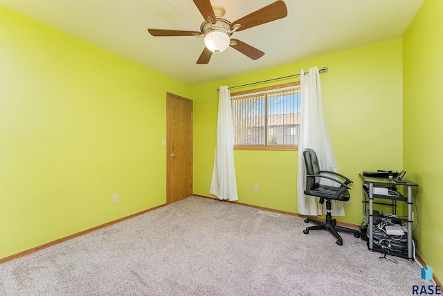 carpeted home office featuring ceiling fan and baseboards