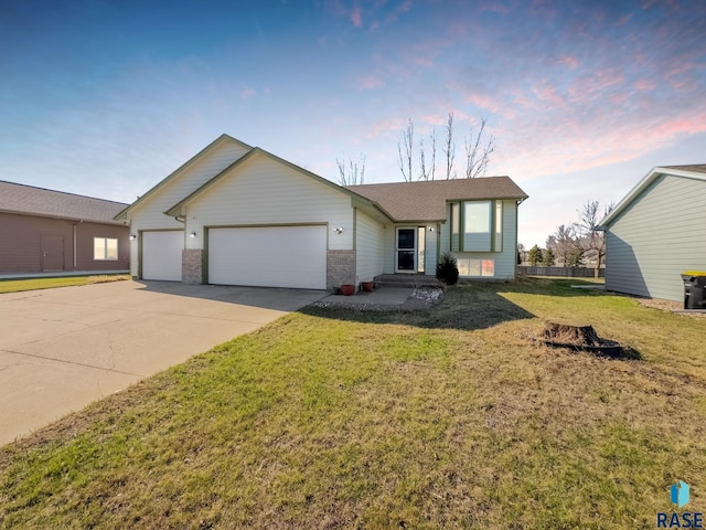 single story home with a yard, roof with shingles, driveway, and an attached garage
