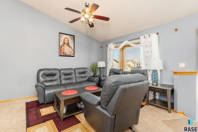 living area featuring light carpet, baseboards, vaulted ceiling, and a ceiling fan